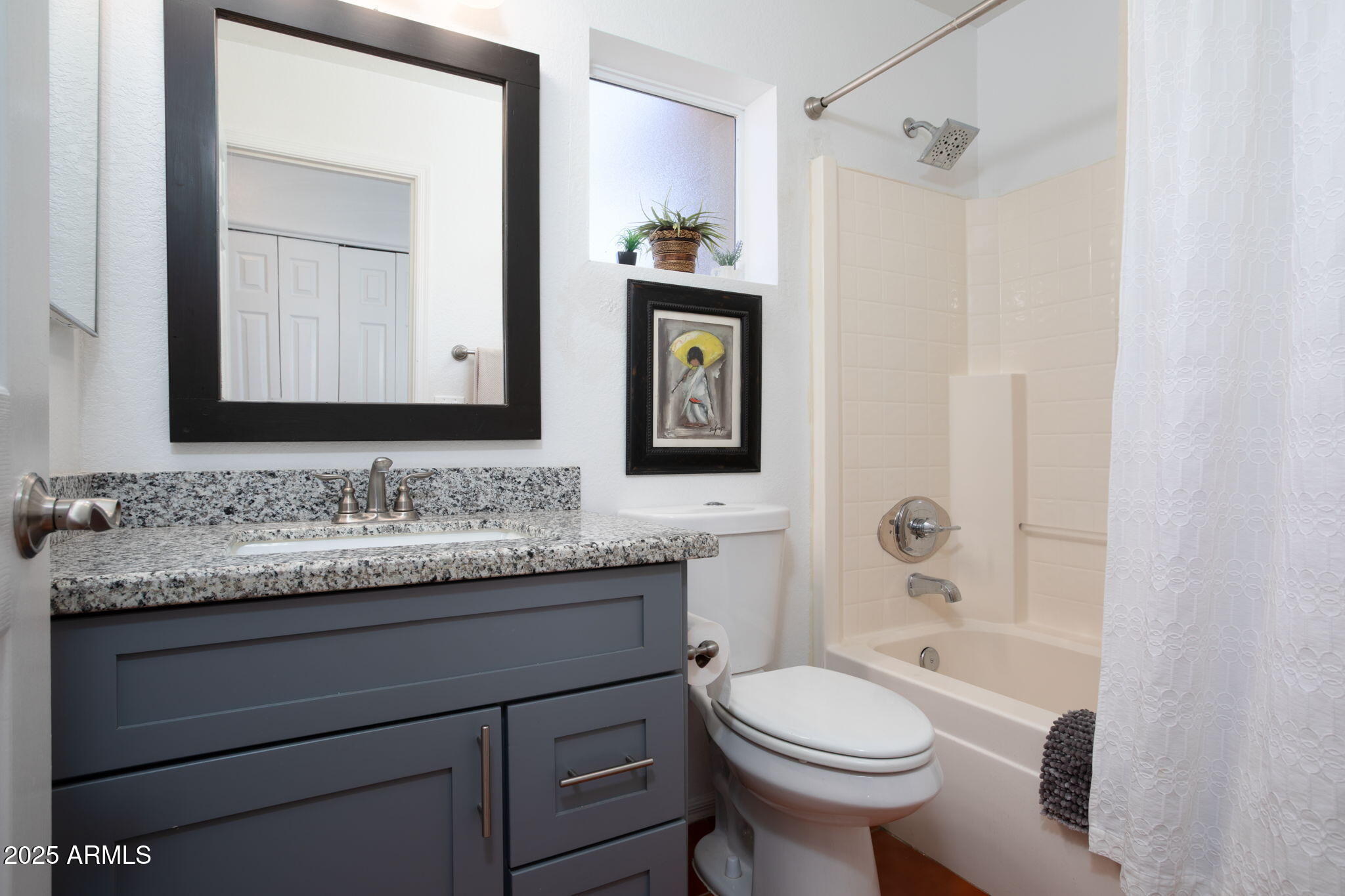 418 Cancun Court Rio Rico, AZ 85648 - Photo 22 of 36 a bathroom with a granite countertop toilet sink and mirror
