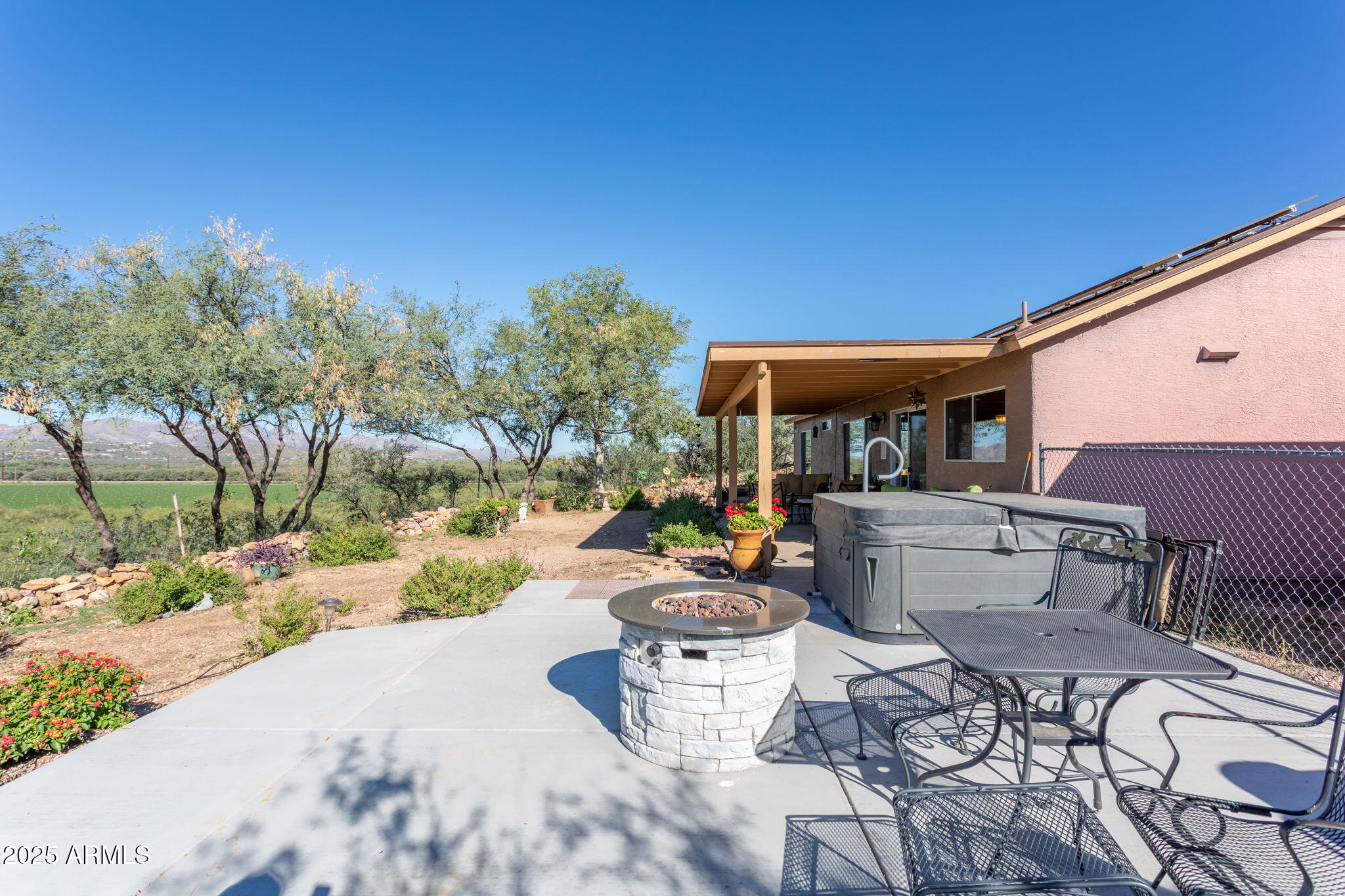 418 Cancun Court Rio Rico, AZ 85648 - Photo 23 of 36 a view of a patio with couches and table and chairs under an umbrella