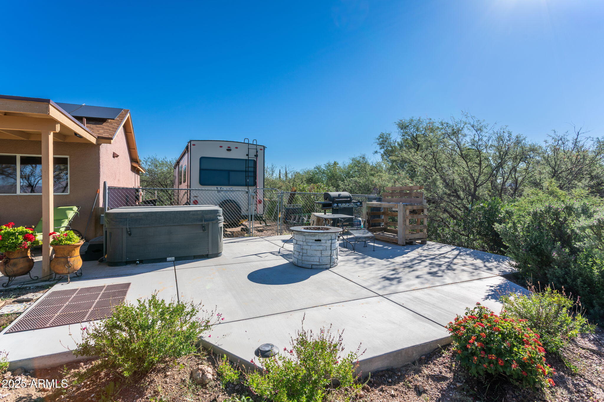 418 Cancun Court Rio Rico, AZ 85648 - Photo 26 of 36 a view of backyard with seating space and trees in the background