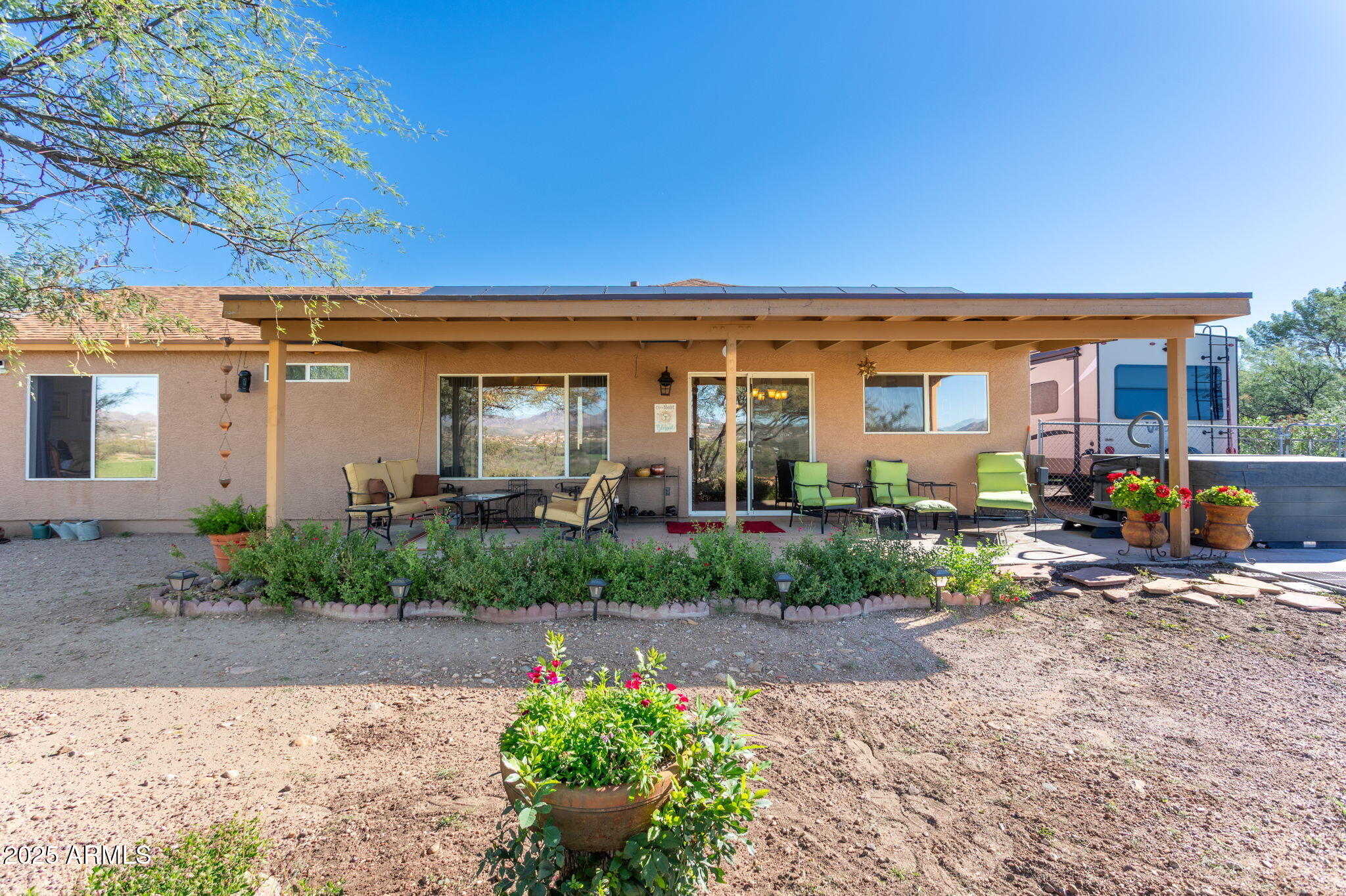 418 Cancun Court Rio Rico, AZ 85648 - Photo 27 of 36 a front view of a house with a yard and outdoor seating