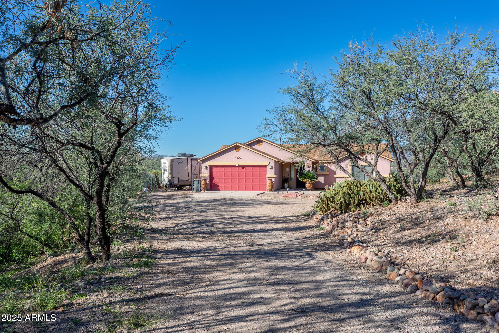 418 Cancun Court Rio Rico, AZ 85648 - Photo 5 of 36 a house with trees in front of it