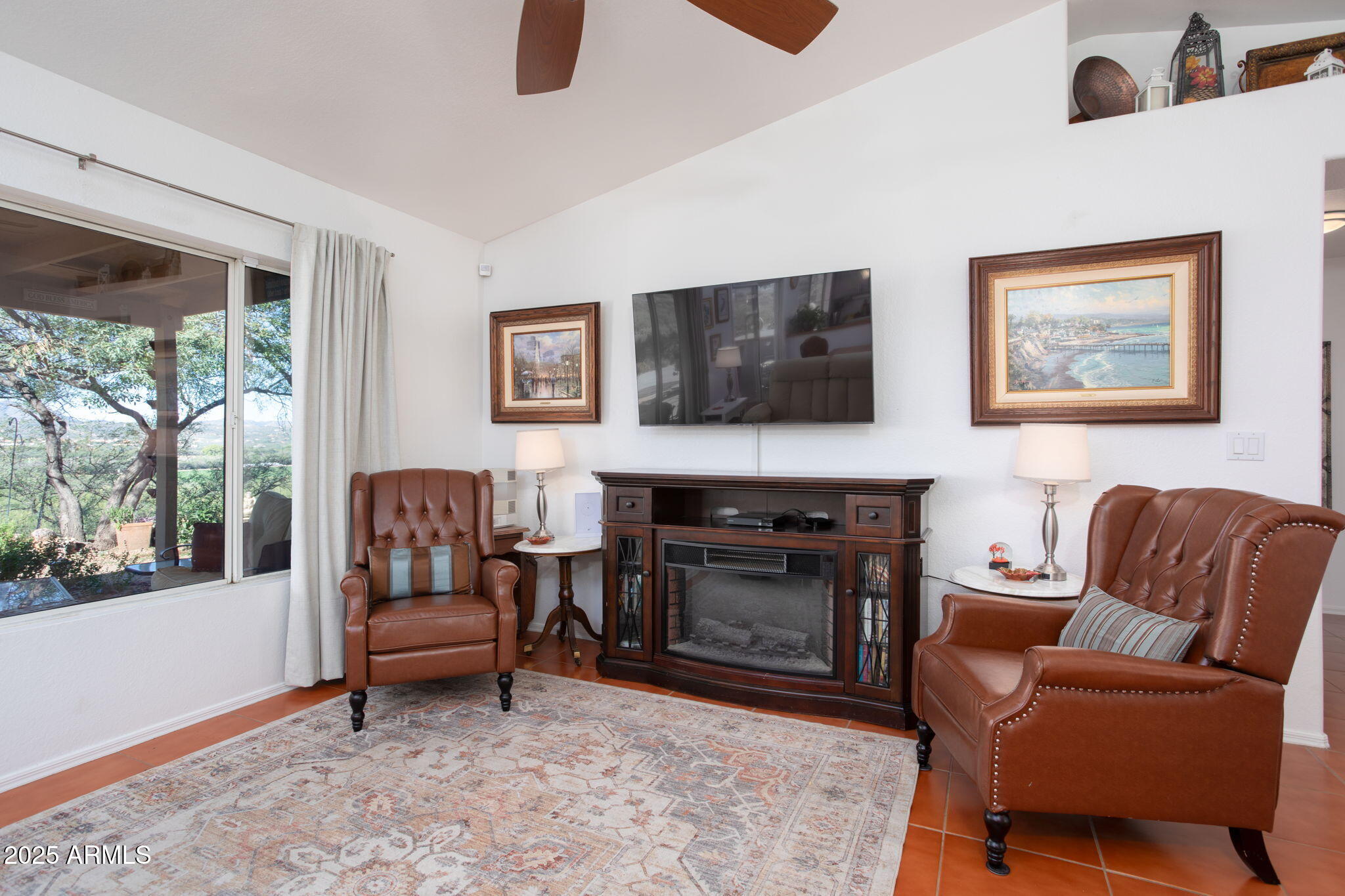 418 Cancun Court Rio Rico, AZ 85648 - Photo 10 of 36 a living room with furniture a flat screen tv and a fireplace