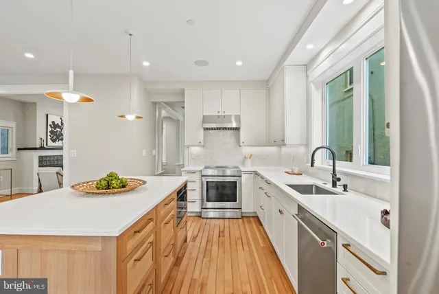 a kitchen with a sink stove and cabinets