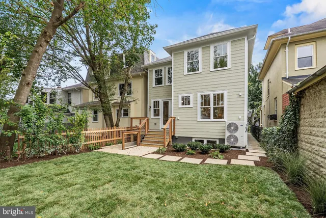 a view of a house with backyard sitting area and garden