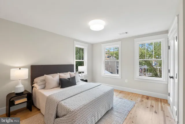 a bedroom with a large bed and a large window