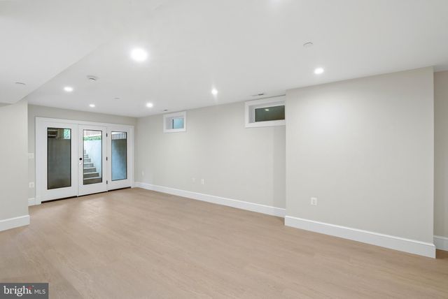 an empty room with entrance and windows