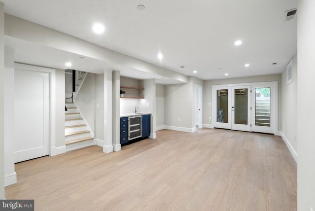 an empty room with a fireplace and entryway