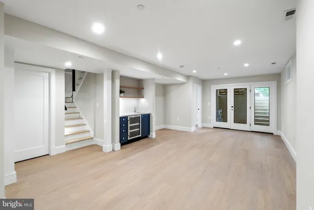an empty room with a fireplace and entryway