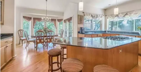 a view of a dining room with furniture water view and wooden floor