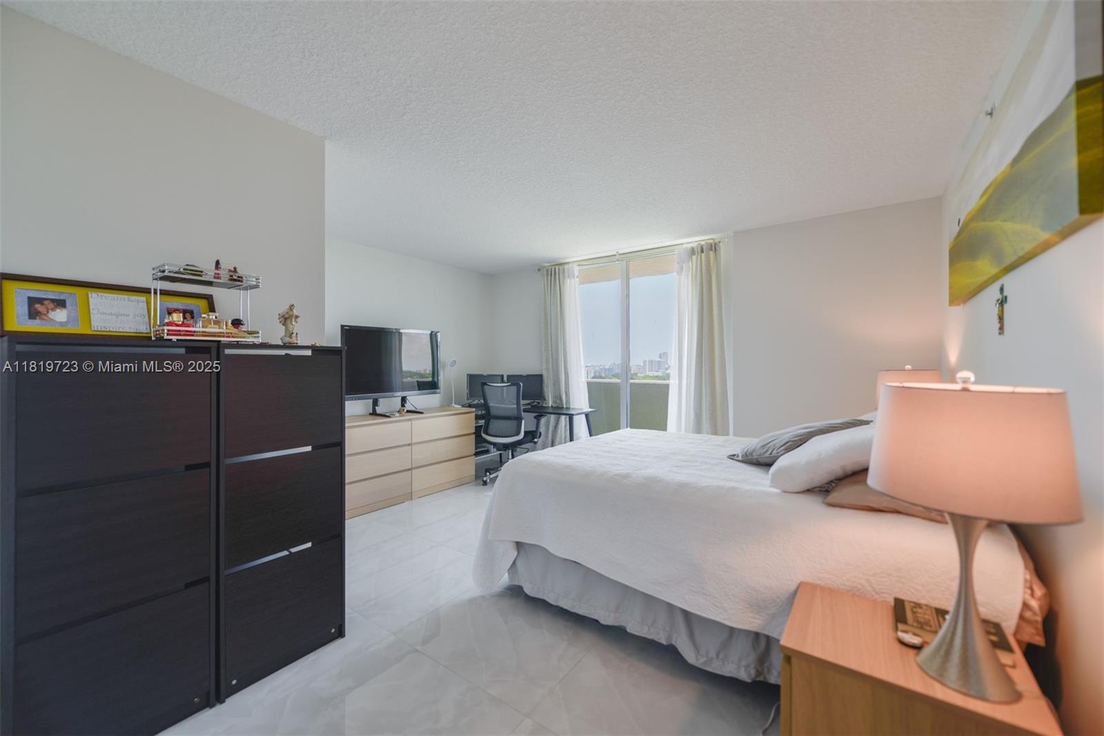 3000 Coral Way, Unit 1208 Miami, FL 33145 - Photo 12 of 35 a bedroom with a bed and a flat screen tv