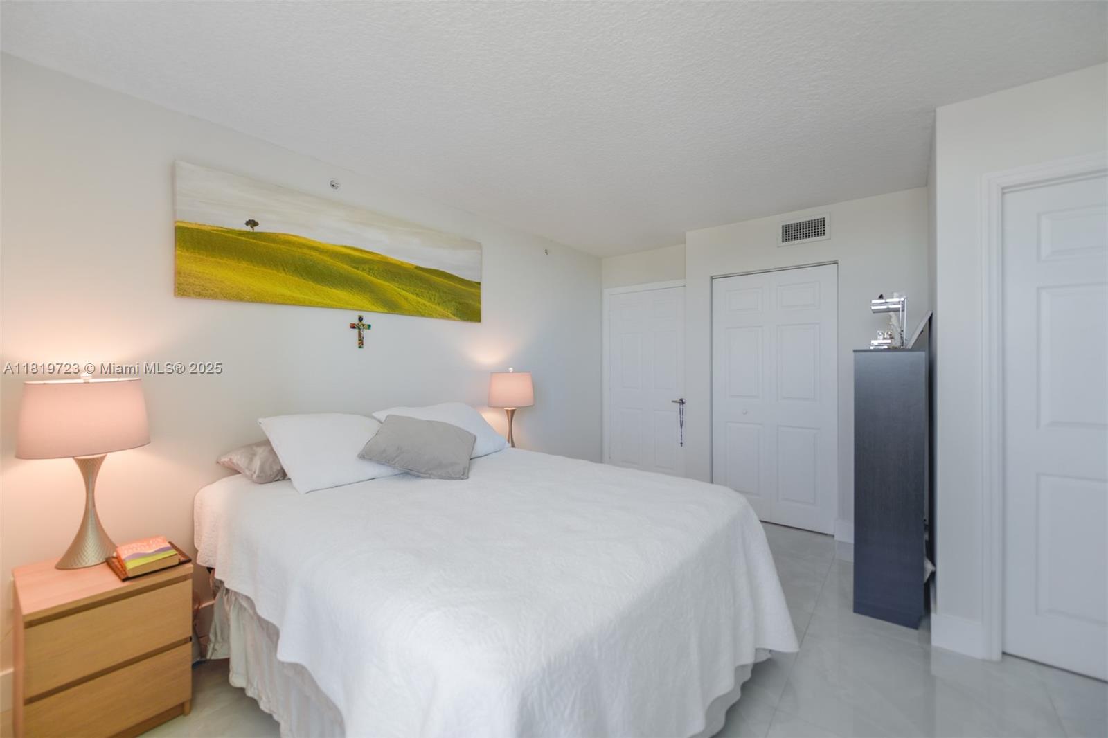 3000 Coral Way, Unit 1208 Miami, FL 33145 - Photo 14 of 35 a bedroom with a bed and lamps
