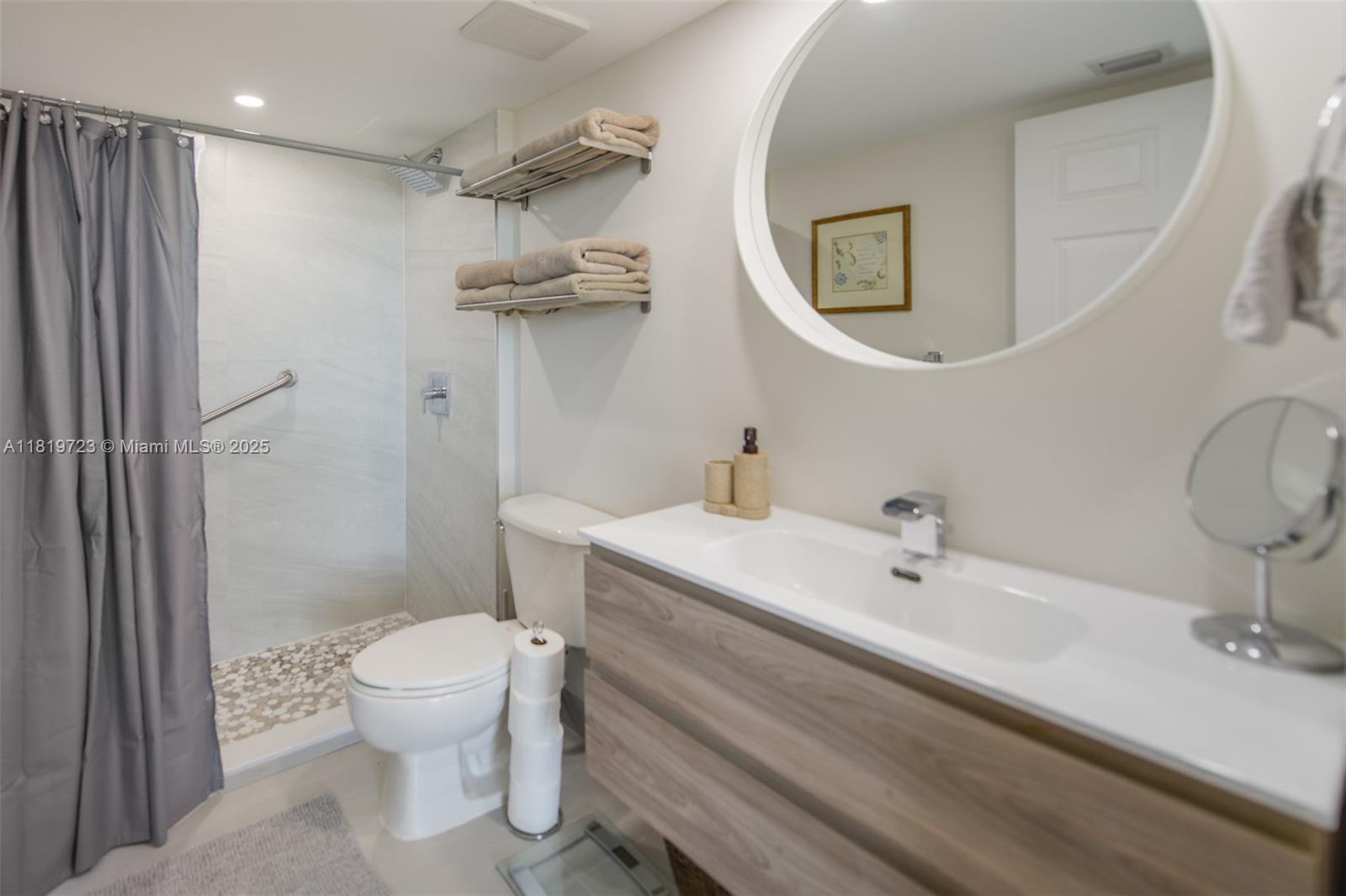 3000 Coral Way, Unit 1208 Miami, FL 33145 - Photo 15 of 35 a bathroom with a sink a toilet and shower