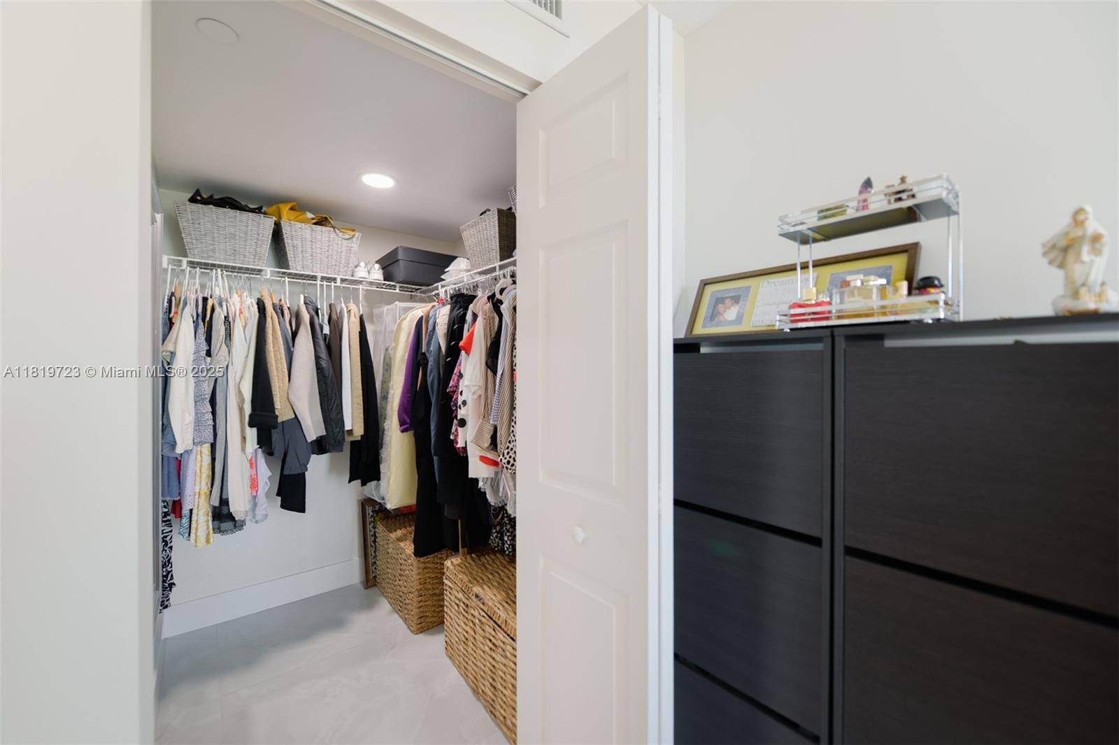 3000 Coral Way, Unit 1208 Miami, FL 33145 - Photo 16 of 35 a view of walk in closet with clothes and shoes