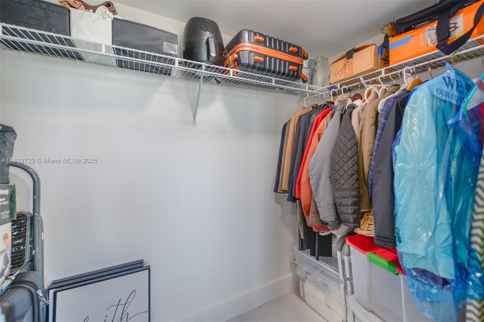 3000 Coral Way, Unit 1208 Miami, FL 33145 - Photo 20 of 35 a view of walk in closet with clothes and shoes