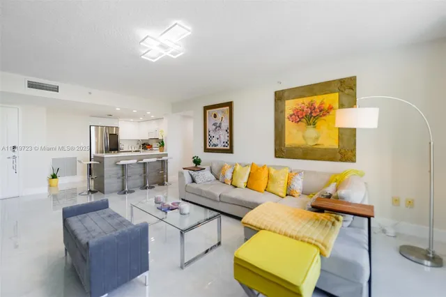 a living room with furniture and kitchen view