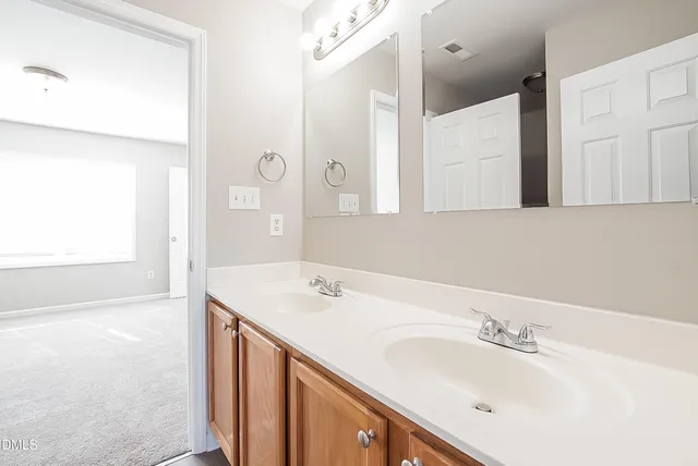 a bathroom with a sink a vanity and a mirror