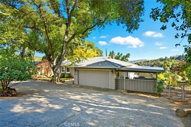 a view of a house with a patio and a yard