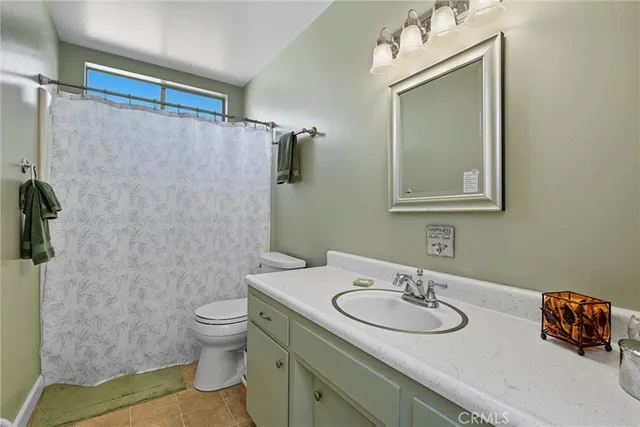 a bedroom with furniture and a large window