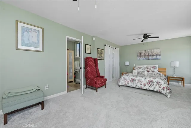 a view of a room with a large window and wooden floor