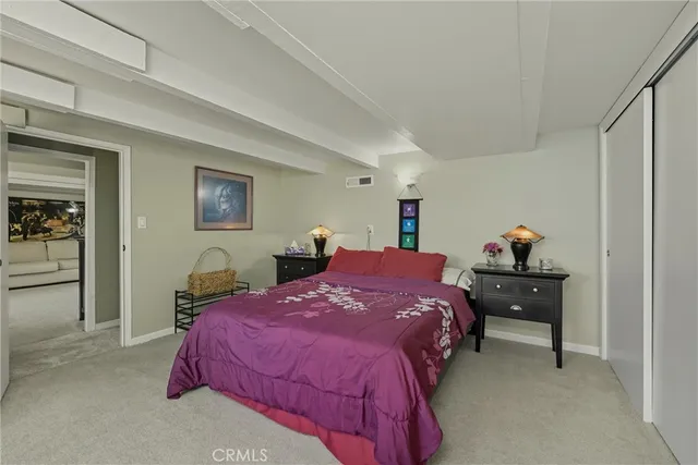 a living room with furniture and a book shelf