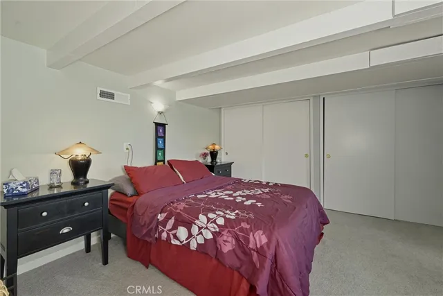 a living room with furniture and a painting on the wall