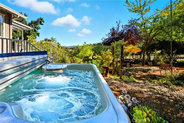 a view of an outdoor space with table and chairs under an umbrella