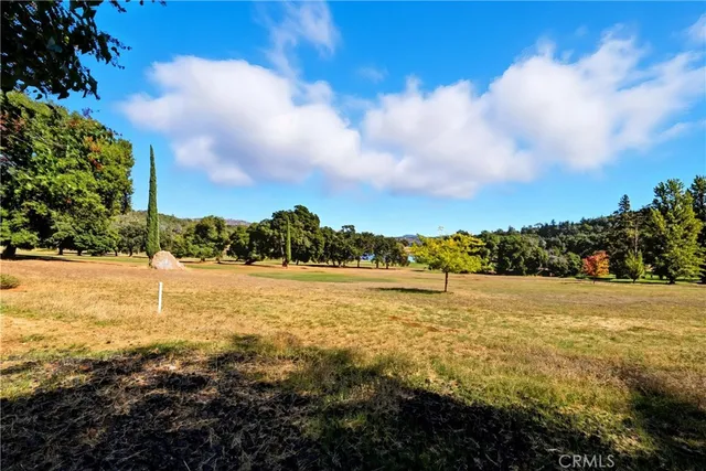 a wooden bench sitting in the middle of a yard