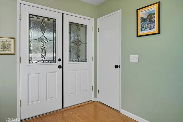 a living room with fireplace furniture and a large window