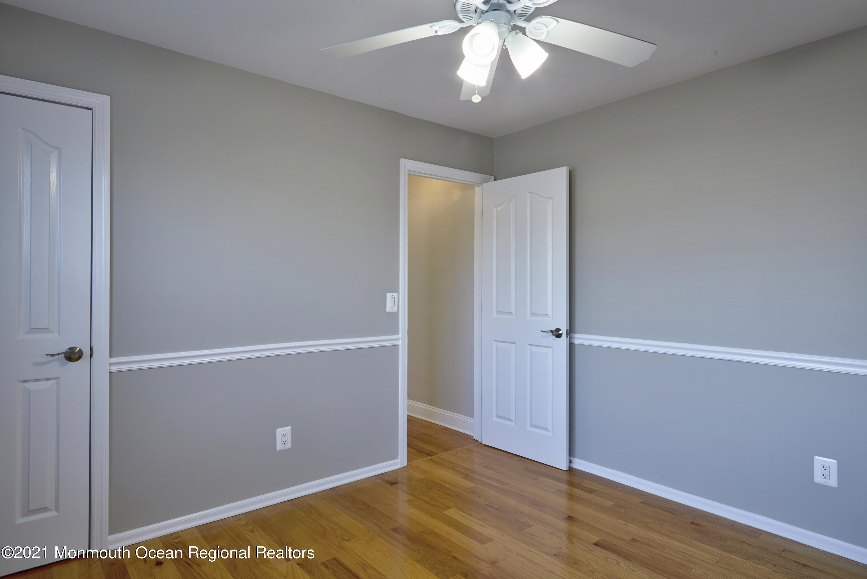 6 Topsail Road Brick, NJ 08723 - Photo 17 of 43 an empty room with wooden floor and chandelier fan