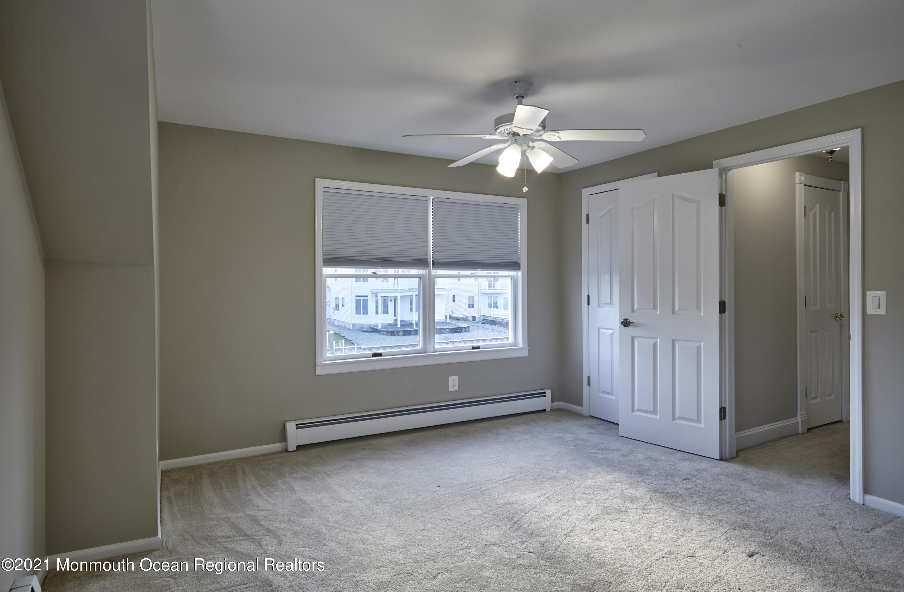 6 Topsail Road Brick, NJ 08723 - Photo 20 of 43 an empty room with chandelier fan and windows