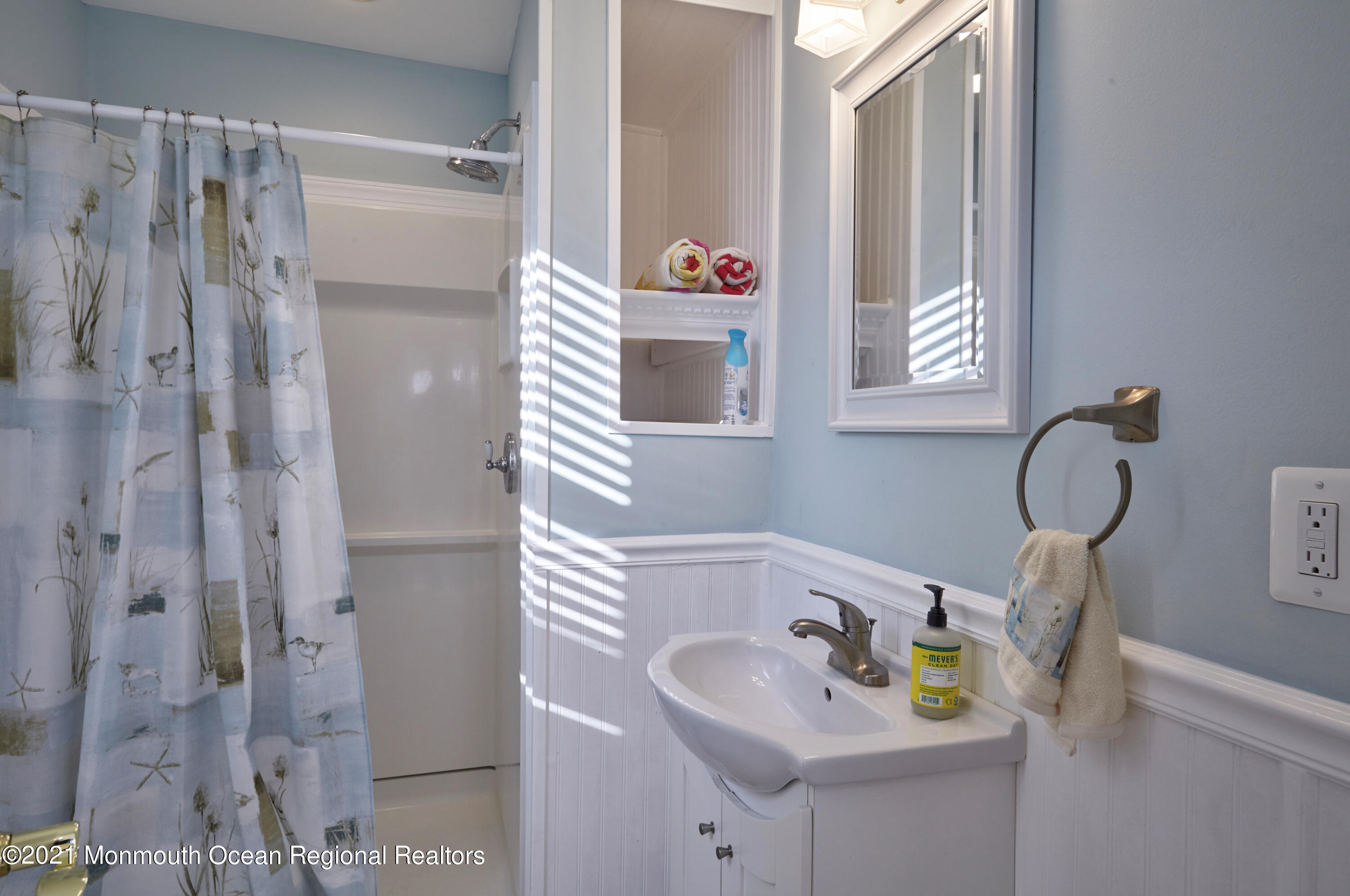 6 Topsail Road Brick, NJ 08723 - Photo 33 of 43 a bathroom with a sink and a shower curtain