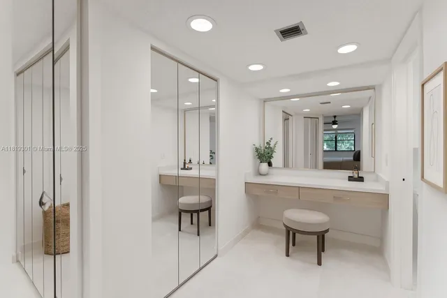 a spacious bathroom with a toilet a sink and mirror