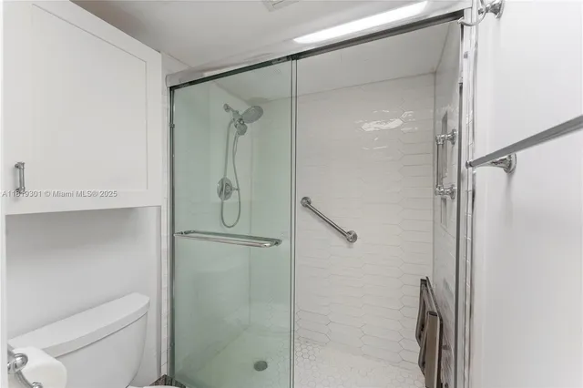 a bathroom with a shower and a toilet