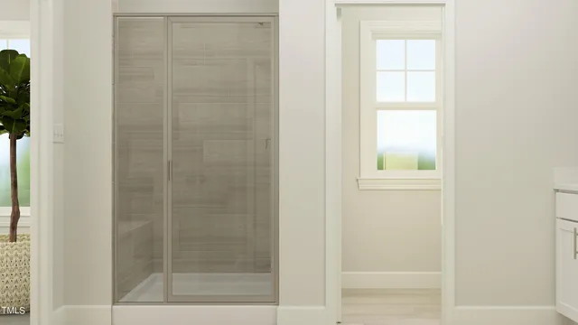 a bathroom with a glass shower door