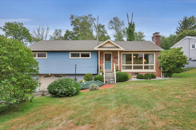 a front view of a house with a garden