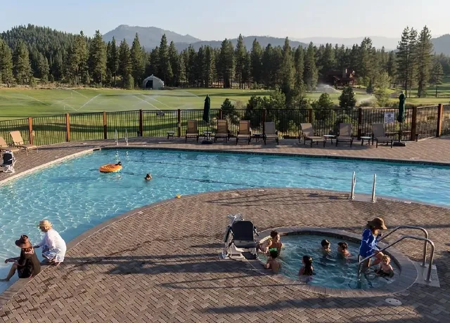 a view of outdoor space with seating area and trees in the background