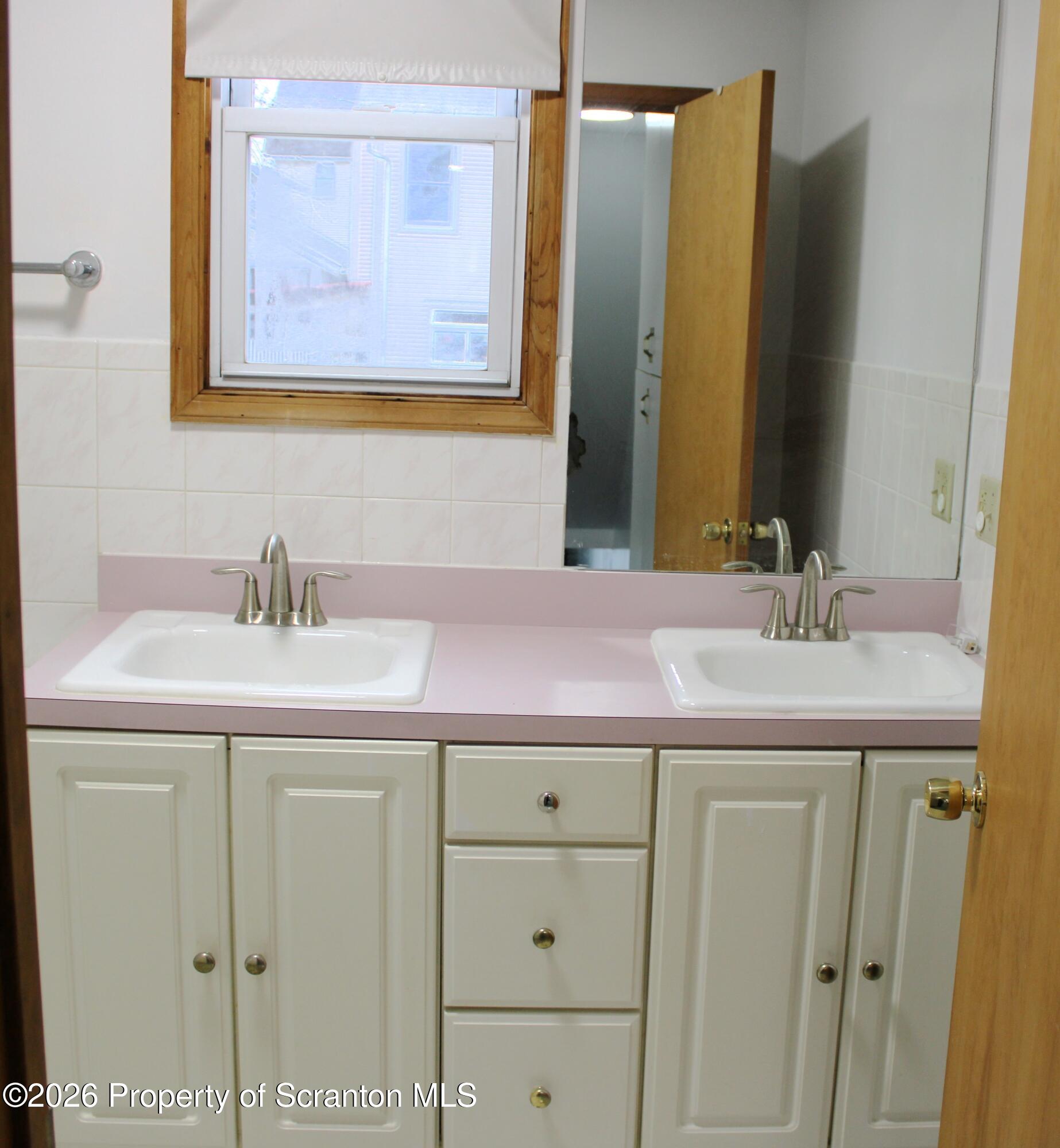 1329-1331 Oram Street Scranton, PA 18504 - Photo 14 of 29 a bathroom with a sink and a mirror