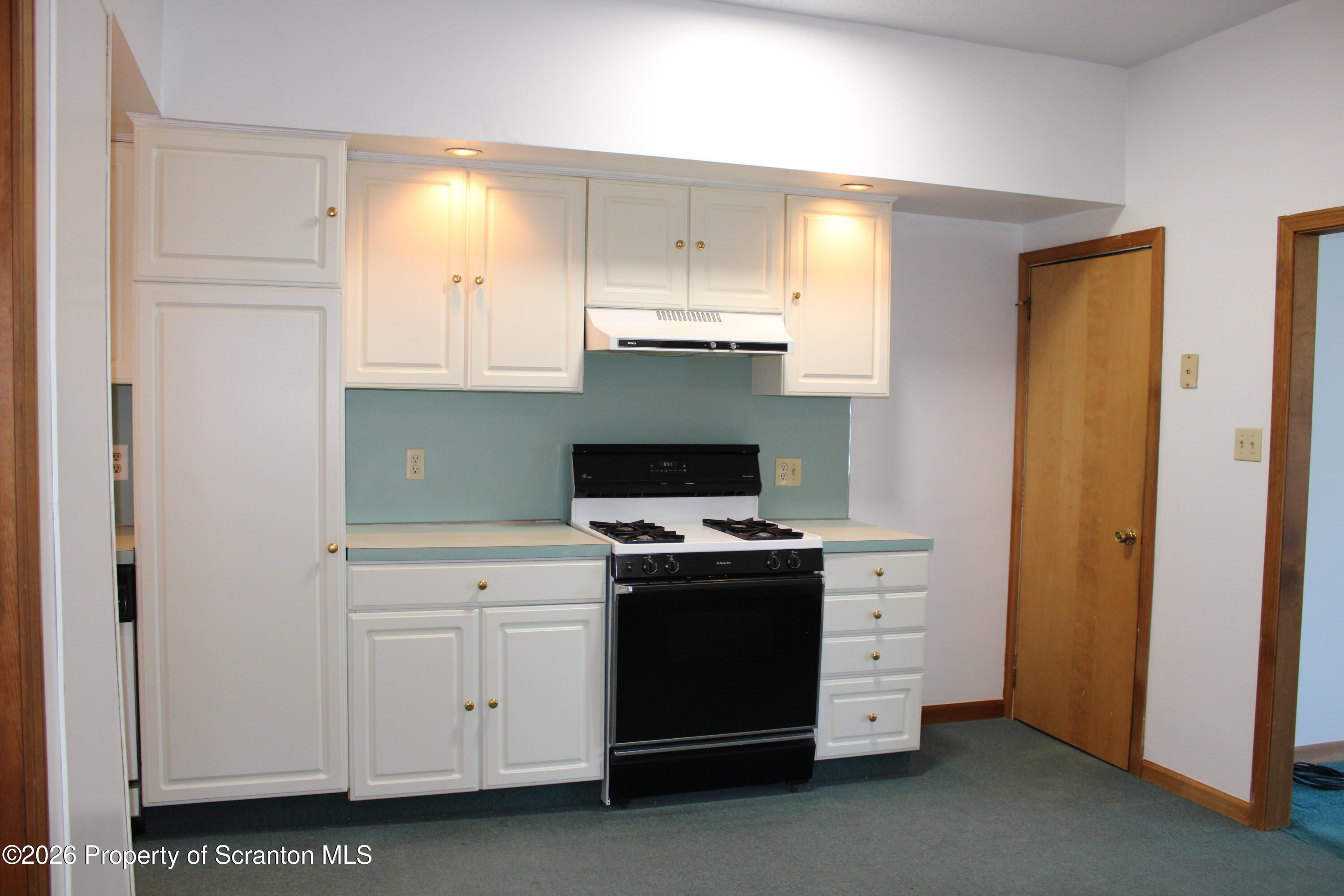 1329-1331 Oram Street Scranton, PA 18504 - Photo 15 of 29 a kitchen with white cabinets and stainless steel appliances