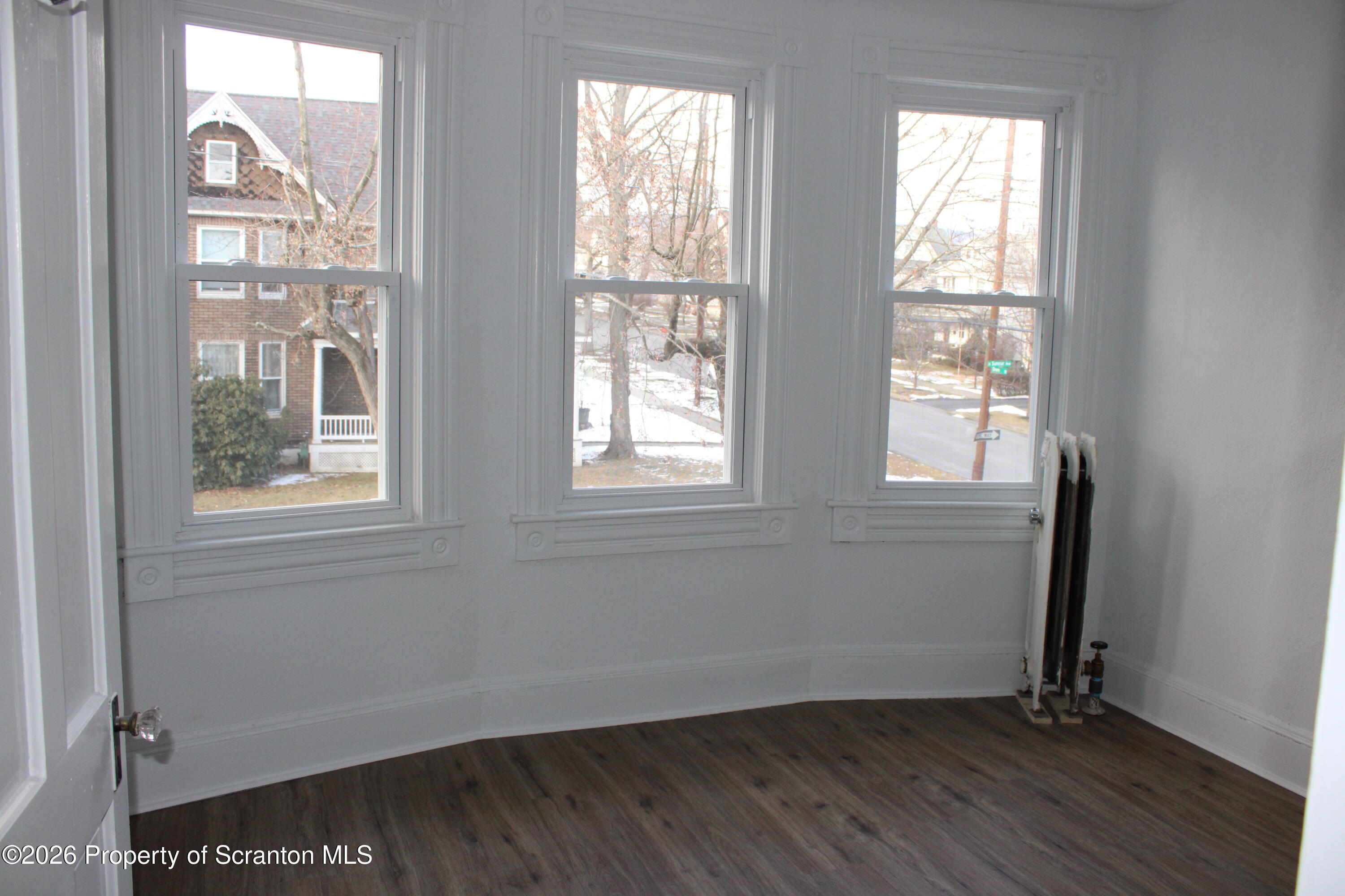 1329-1331 Oram Street Scranton, PA 18504 - Photo 23 of 29 an empty room with wooden floor and windows