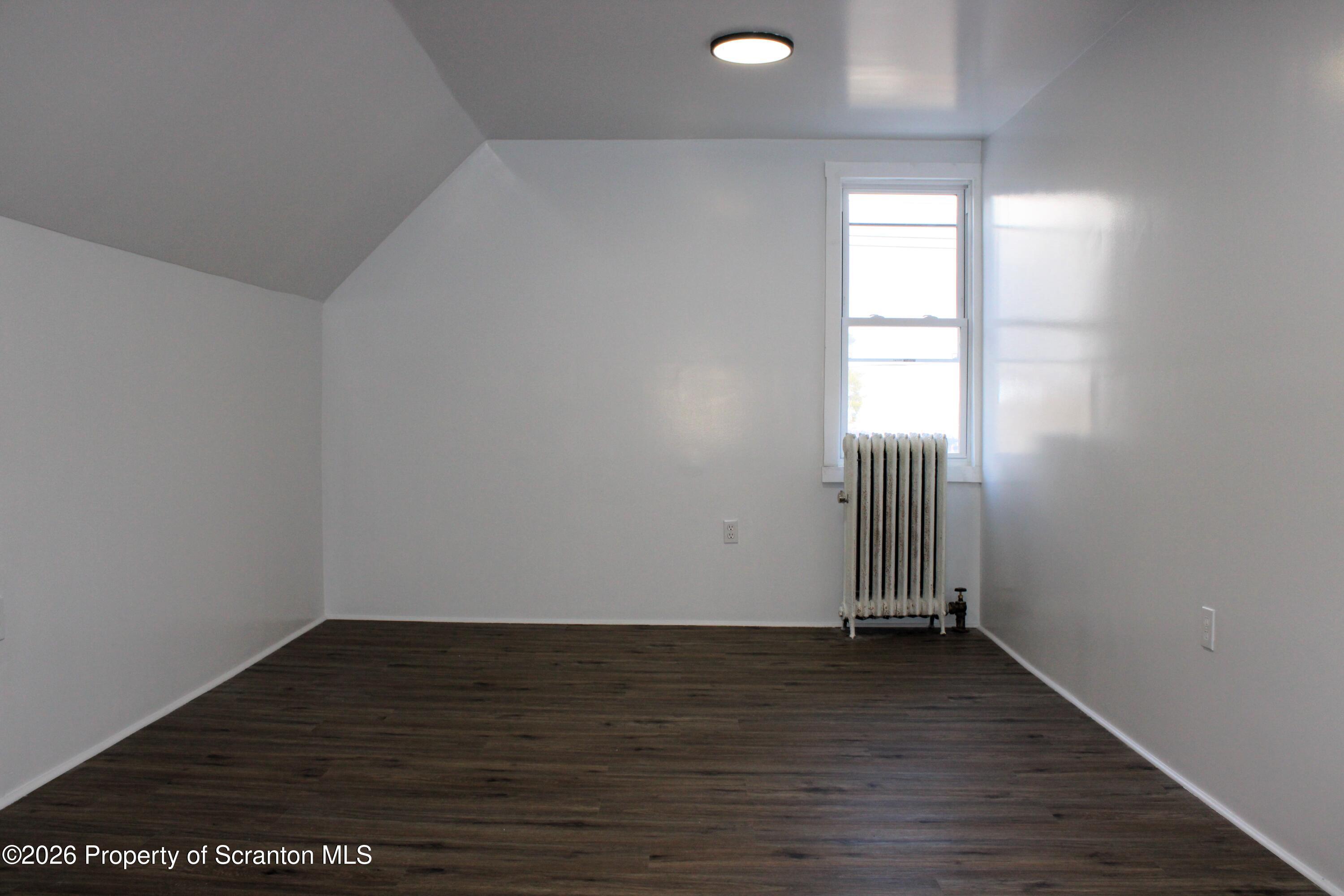 1329-1331 Oram Street Scranton, PA 18504 - Photo 24 of 29 an empty room with wooden floor and windows