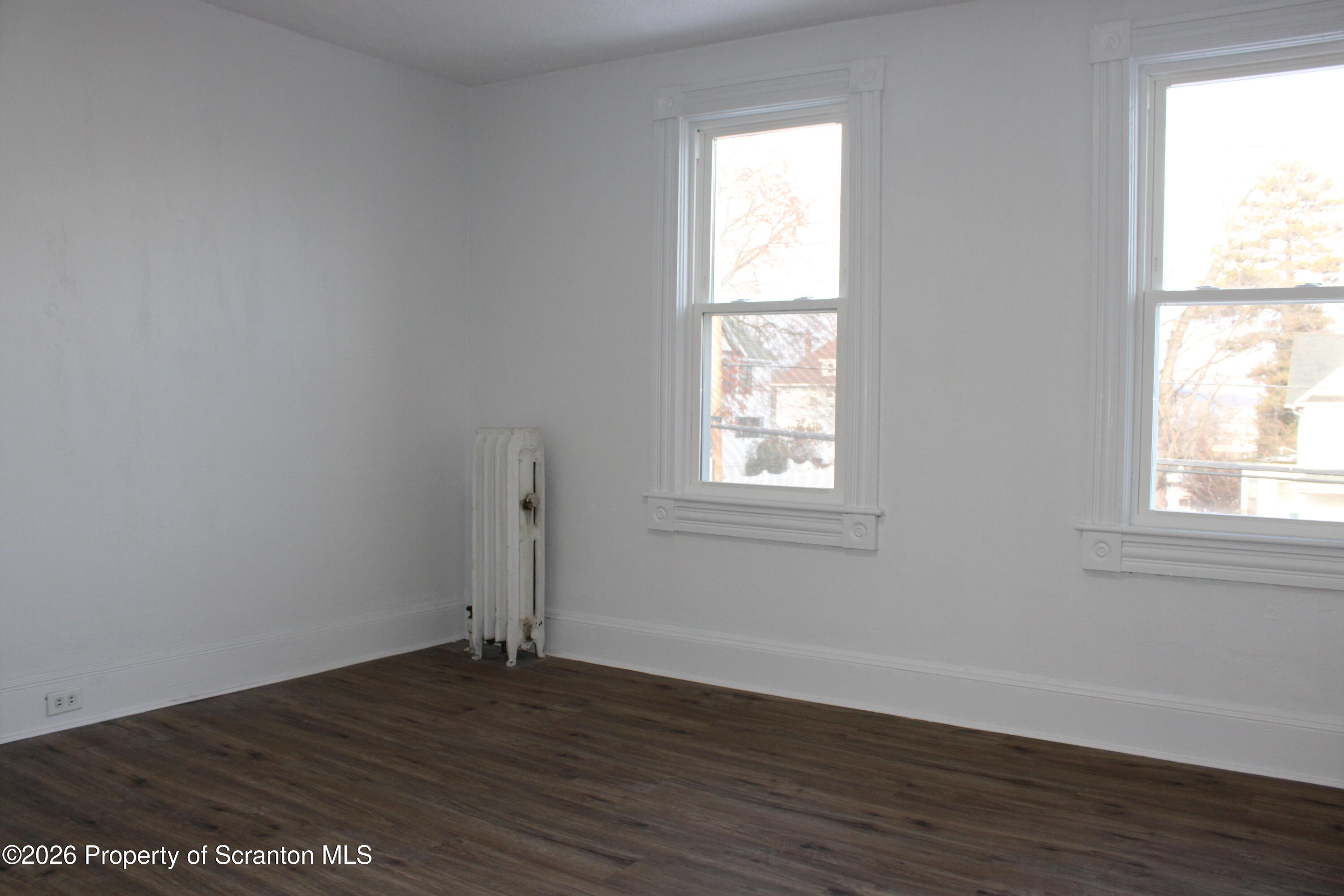1329-1331 Oram Street Scranton, PA 18504 - Photo 27 of 29 an empty room with wooden floor and windows