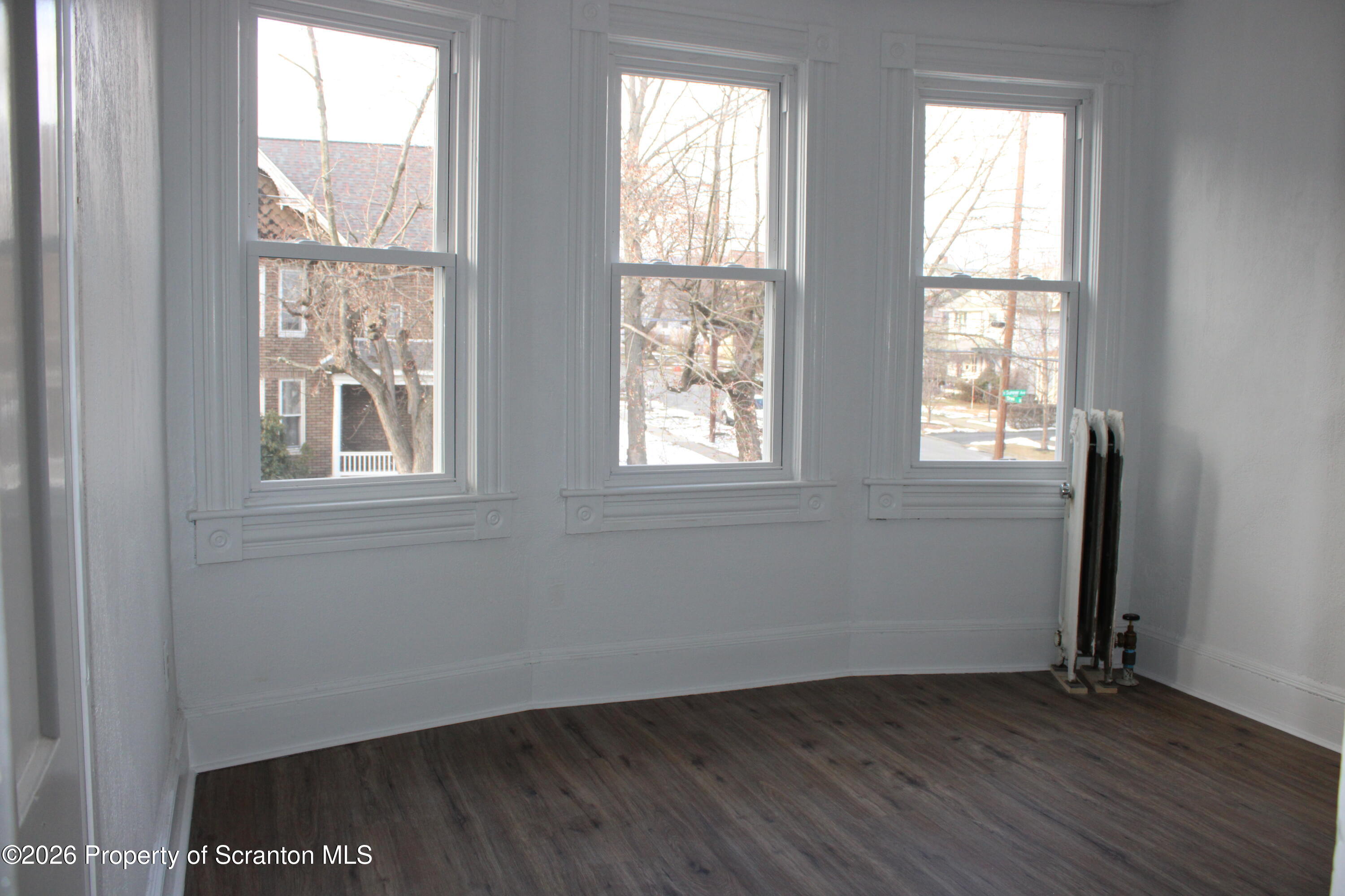 1329-1331 Oram Street Scranton, PA 18504 - Photo 28 of 29 a view of an empty room with wooden floor and windows