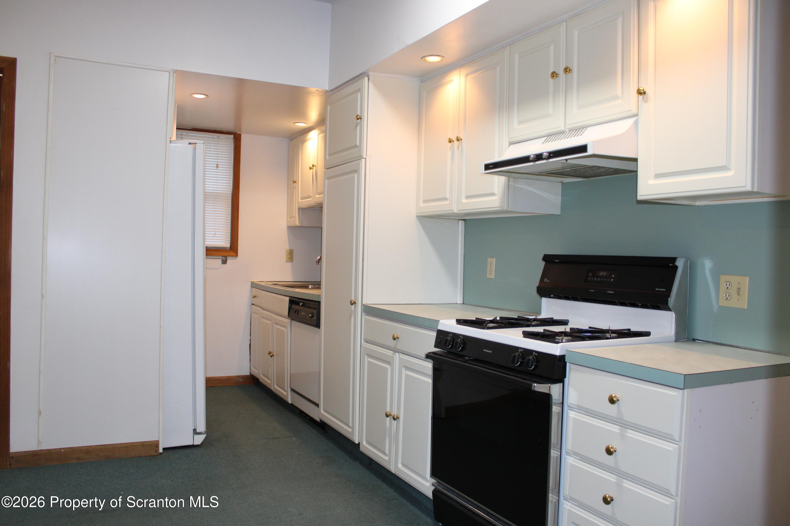 1329-1331 Oram Street Scranton, PA 18504 - Photo 10 of 29 a kitchen with stainless steel appliances white cabinets and a stove