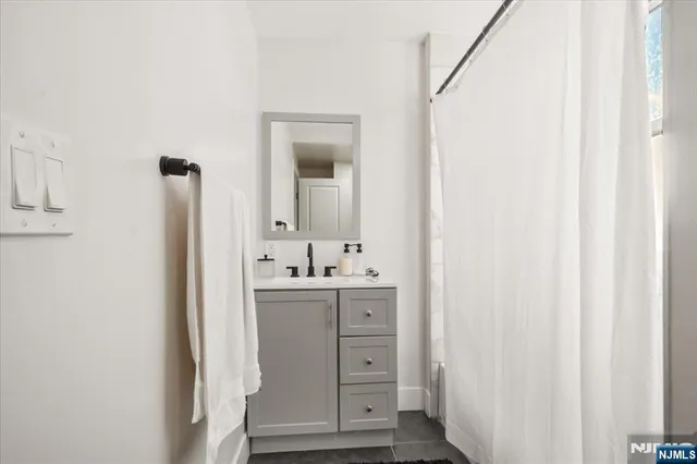 a view of bathroom with a sink and a mirror
