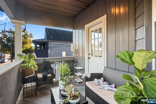 a vase of flowers sitting on a table in a patio