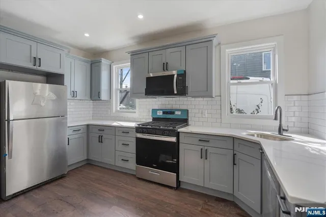 a kitchen with a sink stove and refrigerator