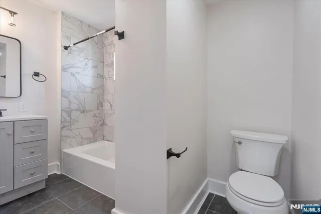 a bathroom with a toilet and a bathtub