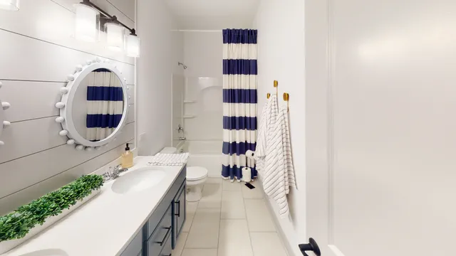a bathroom with a double vanity sink mirror and shower