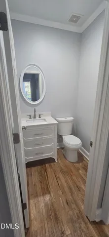 a bathroom with a toilet a sink and a mirror