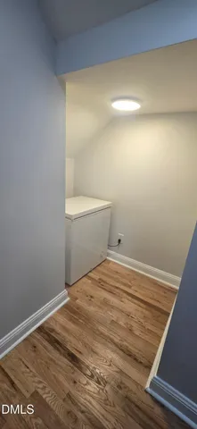 a view of a room with wooden floor and toilet
